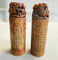 Front view of both soapstone seals showing dragon finials and calligraphy