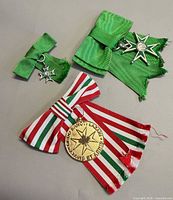 Overview of three medals showing ribbons and insignia