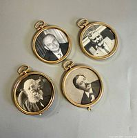 Front view of four round brass photo frames with portraits