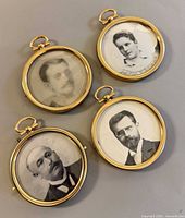 Front view of four brass round locket photo frames showing portraits and brass finish