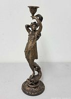 Full view of figural candlestick showing overall form and height