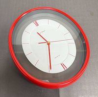 Angled view highlighting red frame and glass cover