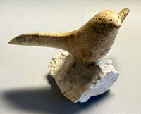 angled view showing full bird and stone base