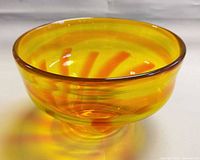 Oblique top view of yellow and orange hand blown glass bowl