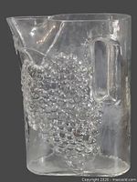 Front view showing grape relief and handle