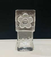Front view of square clear glass vase showing frosted flower motif and textured lower section