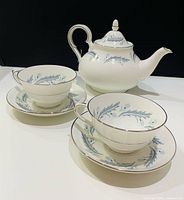full tea set showing teapot, two cups and saucers