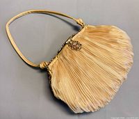 Full view of pleated fabric evening bag with strap