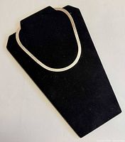 Full necklace displayed on black stand