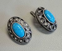 Front view showing blue cabochons and filigree design