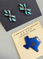 Earrings and Texas brooch on display cards