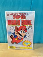 Front cover of Adventures of the Super Mario Bros. #1 bagged and boarded