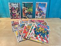 Group of Alpha Flight comics bagged and boarded displayed upright and fanned on table