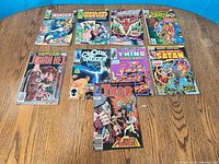 All nine comic books laid out on table