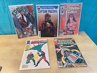 Front covers of all five comics, bagged and boarded