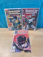 Front covers of RoboCop issues 1-3 in bags with boards