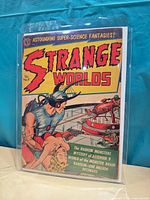 Front view of Strange Worlds No. 9 comic in protective sleeve