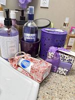 All items on countertop: soap, cologne, hand cream box, lip balm gift box, purple containers