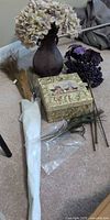 All items in lot: vase with hydrangea, storage box, feathers, faux berry stem