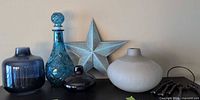 Group shot of all vases, metal star, cast iron keys