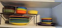 Entire upper shelf showing plates, bowls and shelf riser
