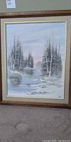 Full front view of framed winter landscape painting