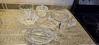 All eight glass and crystal pieces displayed on countertop
