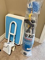 All three items: sealed hip kit package, white bath tub rail, blue-topped bath step