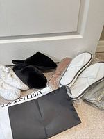 Group shot of slippers and shoe bags on floor