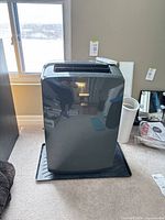 Front view of LG portable air conditioner on floor tray