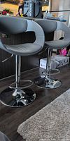 Pair of grey faux leather bar stools full view