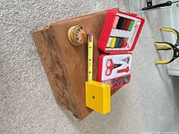 Group view of suede box, sewing kit and round wood box with scale