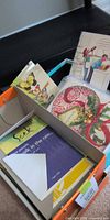 Open box containing variety of greeting cards