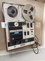 Front view of Akai X-2000SD showing reels, cassette and 8-track sections