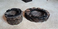 Both carved wood ashtrays top view showing horseshoe rims