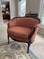 Front three-quarter view showing carved frame and upholstery