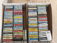 Two open shipping boxes filled with rows of audio cassette tapes