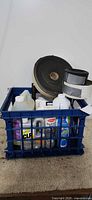 Overall lot showing crate with cleaners and rubber stripping rolls