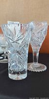 Both cut glass vases side by side