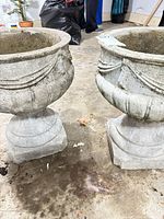 Both cement planters side by side showing overall form and bases