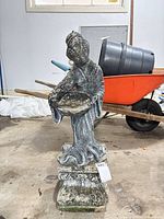Full view of statue on base in garage