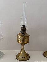 Full view showing brass oil lamp and glass chimney