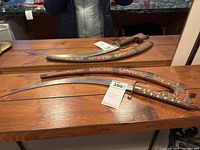 Full view of nimcha and scabbard on wood surface