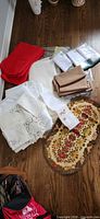 Group of assorted table linens on floor