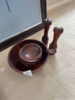 Large bowl with nested small bowls and two tall wooden mills