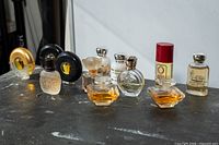 All 12 perfume miniatures grouped on tabletop