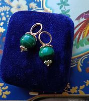 Pair of malachite earring charms on blue velvet pad