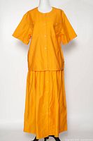 Full view of orange Route cotton shirt and skirt set displayed on mannequin
