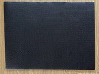Full view of black anti-fatigue mat on wooden floor