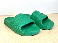 Pair of green Adidas Adilette 22 slides angled front view